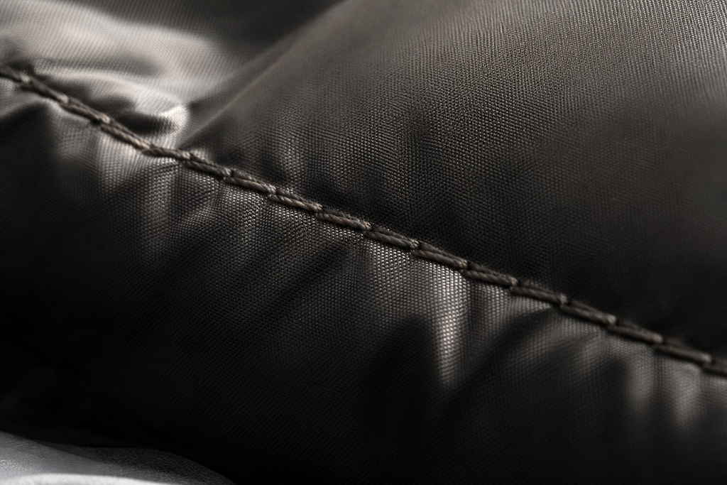 Close-up of a black graphene sleeping bag showcasing its smooth fabric and stitching detail.