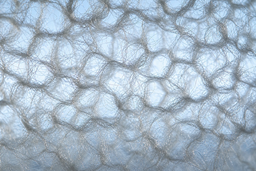 Close-up view of the translucent fabric showcasing the texture used in the alpha direct layering system for backpacking.